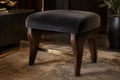 Charcoal velvet accent stool in a luxury interior